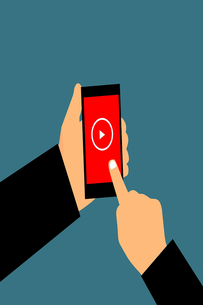 Hand holding a smartphone with a play button icon, representing OTT video-on-demand (VOD) streaming services