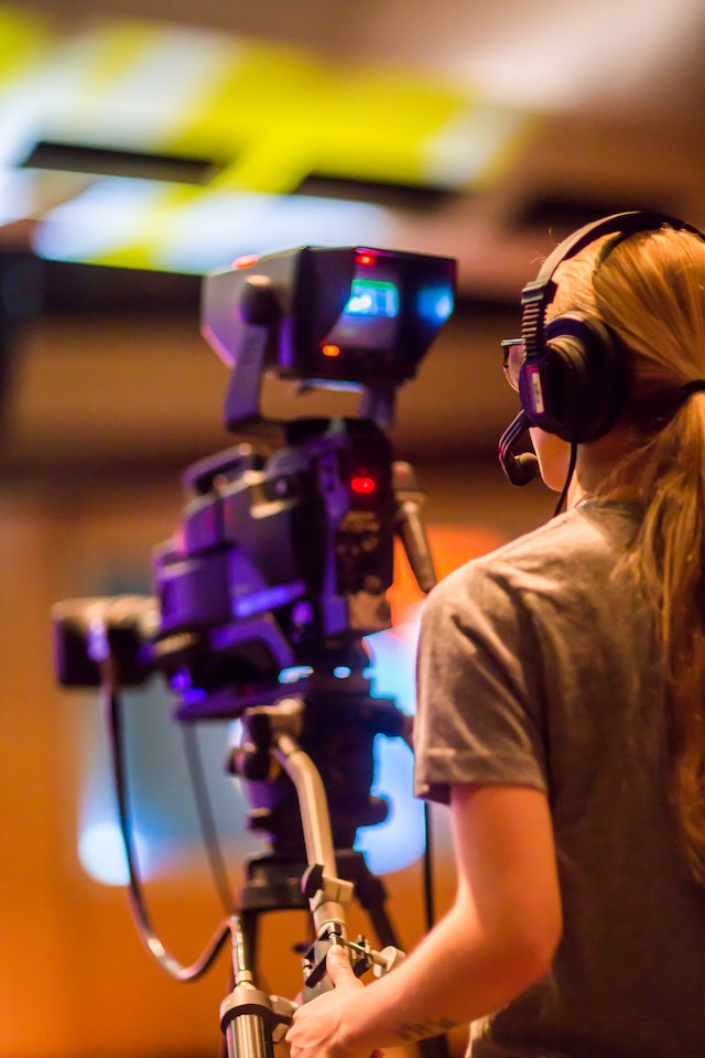 Female camera operator capturing dynamic shots in live broadcast production.